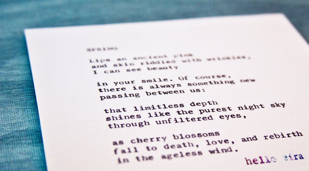 Etsy Typewriter Poetry Poem "Spring." Dutch angle against blue wood card stock. Watermark: hello eira
